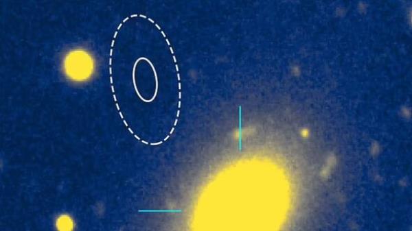 They traced it back to a dead galaxy (yellow oval). The exact origin is outside of the galaxy's center (dotted oval)